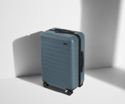 Angled product view of The Bigger Carry-On suitcase in Coast Blue