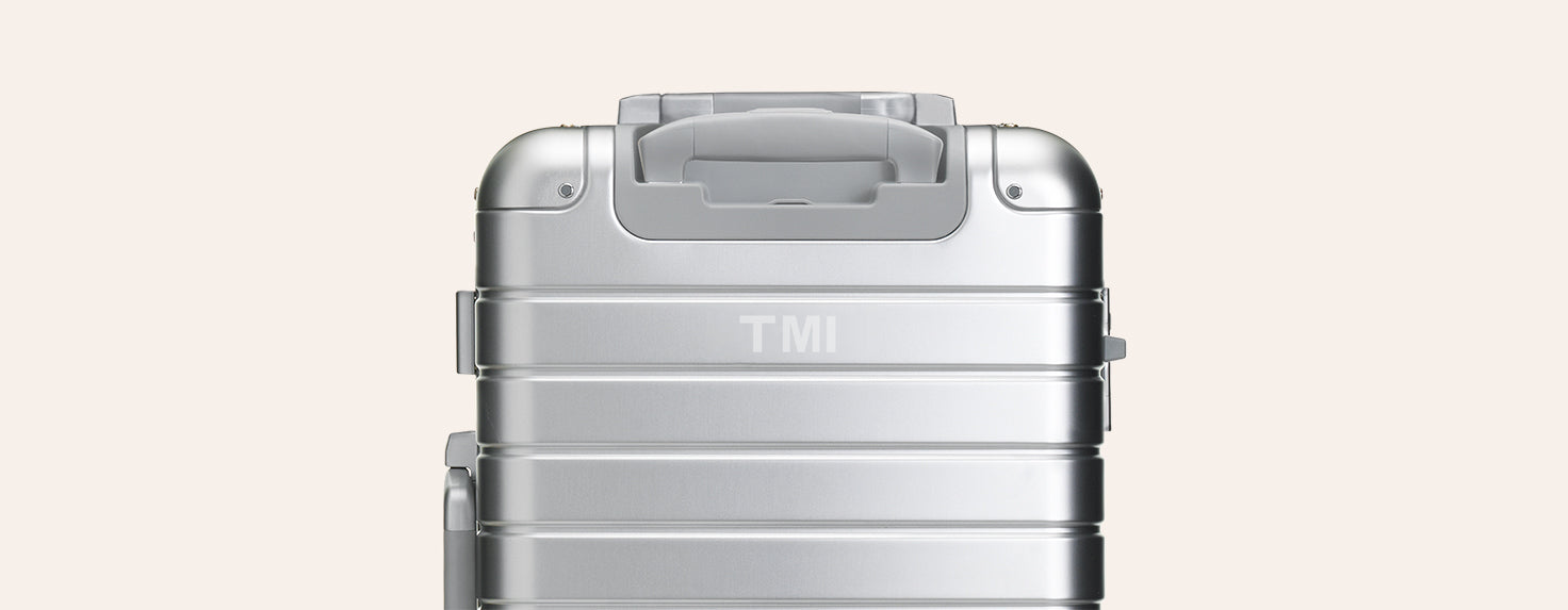 An Aluminum Away suitcase with engraving on the back of the suitcase