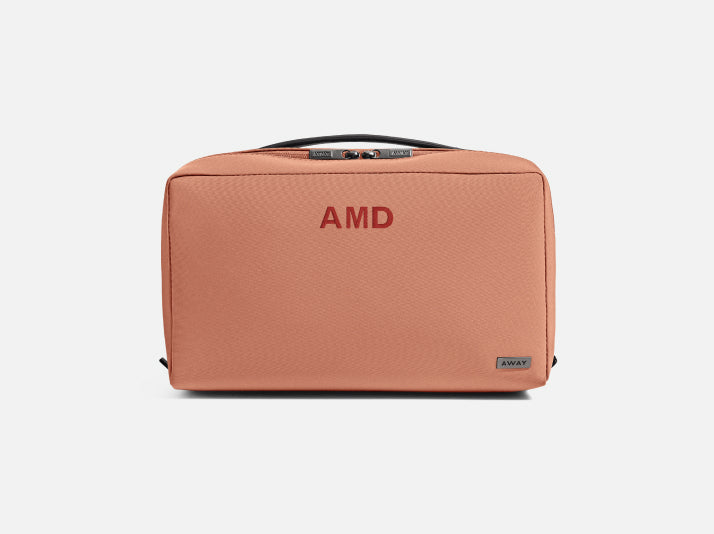 An Away toiletry bag with initials embroidered on the front